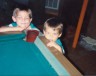 The boys peaking over the edge of the pooltable